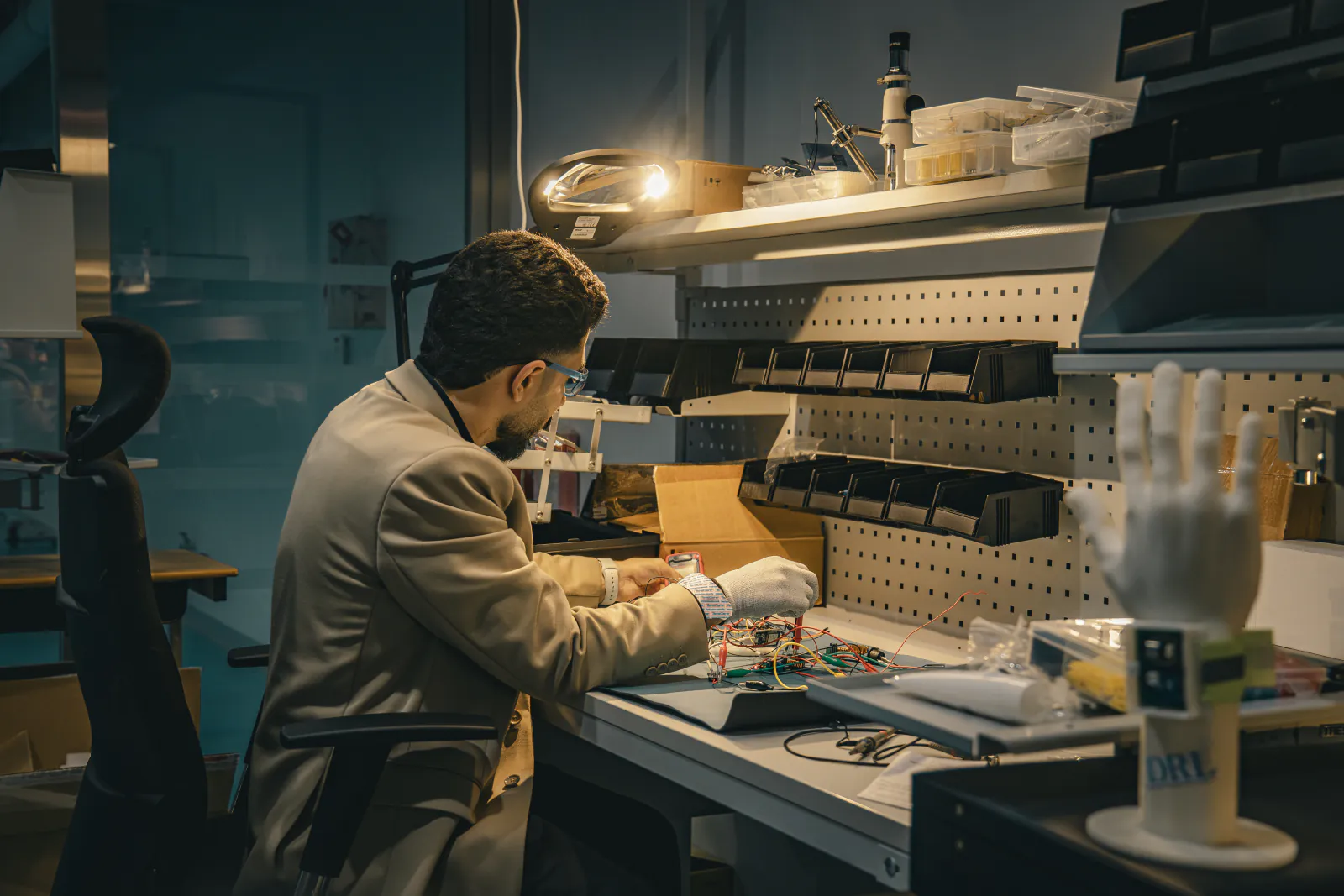 Engineer assembling a prototype at an electronics bench