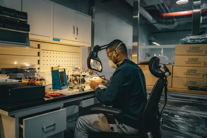 Hand-soldering a board at the bench